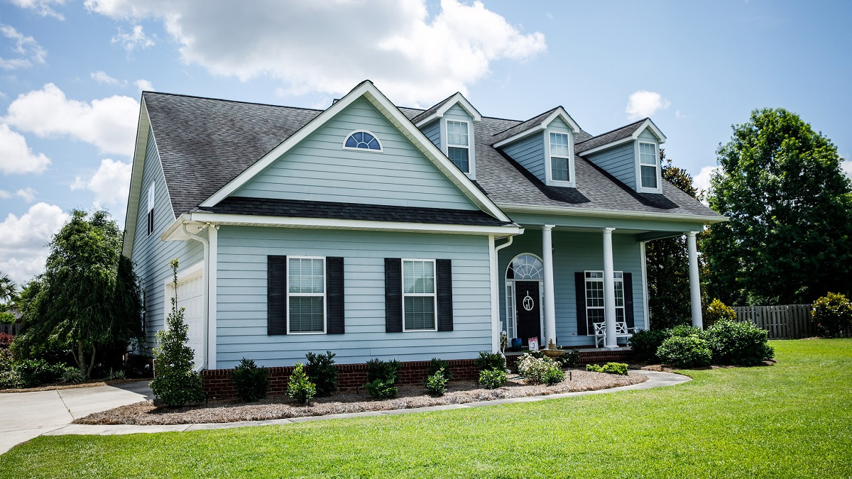 Blue house with pretty green lawn.