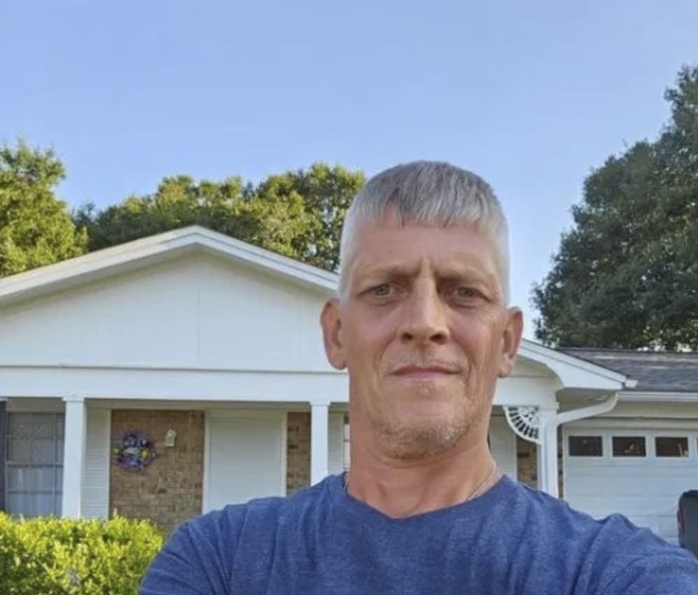 picture of Raymond H. in front of a house